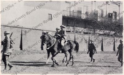 Photograph of two officers, on horses, ...