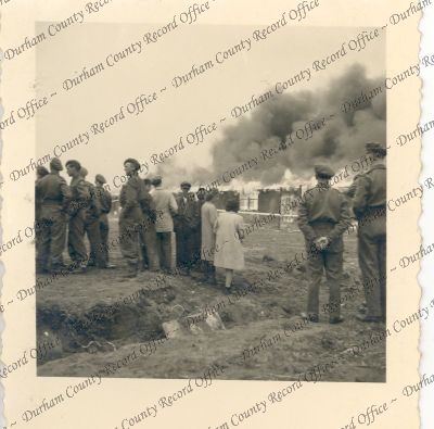 Photograph of soldiers and civilians ob... Photograph of soldiers and civilians ob...