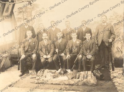 Studio photograph of eleven men holding ... Studio photograph of eleven men holding ...
