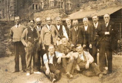 Photograph of group of men taken in back... Photograph of group of men taken in back...