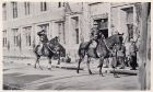 Photograph of Major Heslop, and Captain H.E. Fox-Davies, of the 1st Battalion, The Durham Light Infantry, on horseback, riding past battalion headquarters during a route march, taken at Yu Yuen Road S