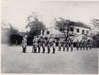 Photograph of officers of the 1st Battalion, The Durham Light Infantry, inspecting soldiers on guard duty, taken at Great Western Road, Shanghai, China, c.1938