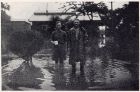Photograph of two unidentified soldiers standing in flood water, taken at Great Western Road, Shanghai, China, c.1938