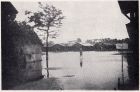 Photograph of an unidentified soldier, standing in a flooded barracks square, taken at Great Western Road, Shanghai, China, c.1938