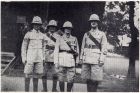 Photograph of the Quartermaster's Staff of the 1st Battalion, The Durham Light Infantry, as follows: Corporal Taylor, left, Sergeant Pirie second left, Major Lowe, second right, and Regimental Quarter