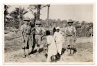 Photograph of three soldiers of 1st Battalion, The Durham Light Infantry, and two Egyptian boys, [Egypt], n.d., [1928]