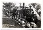 Photograph of a group of soldiers of the 1st Battalion, The Durham Light Infantry, waiting for kit inspection in camp, [Egypt] n.d., [1928]