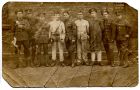 Photograph of a corporal and eight Durham Light Infantry soldiers, not all in uniform, possibly new recruits, n.d., [1920s]