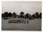 Photograph of unidentified troops, probably the lst Battalion, The Durham Light Infantry, at a passing-out parade, marching past a military band at Blackdown [Barracks], Hampshire, n.d., [1930s]