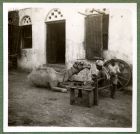 Photograph of a house with a camel, a man and a boy, possibly taken in Aden, c.1941
