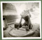 Photograph of a man processing grain, possibly taken in Aden, c.1941