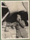 Photograph of a soldier of the 1st Battalion, The Durham Light Infantry, [possibly H.C.R. Lees] with a Chinese boy, captioned S post [31], 7 January 1938