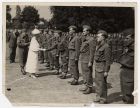 Photograph of Queen Mary inspecting officers of the 10th Battalion, The Durham Light Infantry, and other units engaged in re-equipping after Dunkirk, 1940