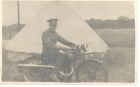 Photograph of soldier Stanley Levitt, 1/5th Battalion, The Durham Light Infantry (54th Searchlight Regiment), (Territorial Army), sitting on a motor cycle in a camp, taken at Redcar, North Yorkshire, 