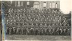 Group photograph of officers and non-commissioned officers [possibly of the 54th Searchlight Regiment, Royal Artillery (The Durham Light Infantry) (Territorial Army)] in the garden of a building, c.19