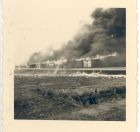 Photograph of the burning of the last remaining hut at Belsen Concentration Camp, taken in Germany, 21 May 1945