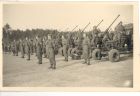 Photograph of soldiers of the 113 Light Anti-Aircraft Regiment, Royal Artillery (Territorial Army), on parade, taken in Germany, 8 May 1945