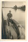 Photograph of a soldier of the 113 Light Anti-Aircraft Regiment, Royal Artillery (Territorial Army), relaxing in a sailing boat, taken at Lübeck, Germany, May - June 1945