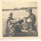 Photograph of a group of soldiers of the 113 Light Anti-Aircraft Regiment, Royal Artillery (Territorial Army), in a German Army assault craft, taken at Lübeck, Germany, May - June 1945