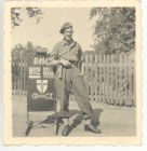 Photograph of Battery Sergeant-Major Stanley Levitt, 113 Light Anti-Aircraft Regiment, Royal Artillery (Territorial Army), standing by a direction sign to the 162 Battery office, taken in Germany, Jun