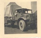 Photograph of Battery Sergeant-Major Stanley Levitt, 113 Light Anti-Aircraft Regiment, Royal Artillery (Territorial Army), sitting in an army truck, taken at Ronnenburg, Germany, June 1945