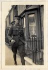 Photograph of an officer of the 6th Battalion The Durham Light Infantry in a street outside officers' billets, captioned: Capt. Walton, 'D' Company, n.d. [1914 - 1915]