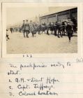 Photograph of three officers of the 6th Battalion The Durham Light Infantry with the pack ponies of the battalion baggage transport in a street, captioned: The Pack Ponies ready to start; 1. Q.M. & Li