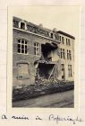 Photograph of a town house with frontage blown in, captioned: A Ruin in Poperinghe, Belgium, n.d. [1915]