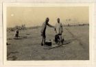 Photograph of Indian soldiers washing behind the lines, captioned: Indian toilet, Belgium, n.d. [1915]