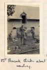 Photograph of farm building with soldiers working, captioned: Second Lieutenant Peacock thinks about washing, June 4 - 15 , Belgium, June 1915