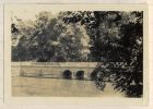 Photograph of a stone, balustraded bridge over a moat, captioned: The Bridge over the Moat, Kemmel, Belgium, n.d. [1915]