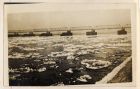 Photograph of an iron railway bridge over a river, captioned: Ice-floes on the Vistula near its mouth, West Prussia, Germany, 1918