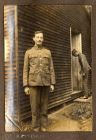 Photograph of officer cadet H. McBain outside a barrack hut with Lance-Corporal Ball in the background, Romford, Essex, n.d. [1916]