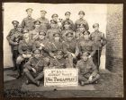 Group photograph of four officers and 16 other ranks, members of the 2nd Battalion The Durham Light Infantry concert party 'The Pineapples', taken at Noeux Les Mines, France, September 1917 
Second r