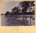 Photograph of barrack rooms of The Durham Light Infantry surrounded by water during the floods, Mandalay, Burma, 1899