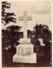 Photograph of a memorial cross bearing the inscription 'in memory of the officers, N.C.O.s, men, women and children of the 2nd Durham Light Infantry who died while the Battalion was quartered at Ghorp