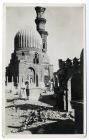 Photograph of a domed mosque with graves in front and a tower behind, possibly in Egypt, c.1942