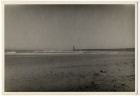 Photograph of a seashore, with a breakwater and tower, possibly the entrance to a port, North Africa, c.1942