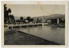 Photograph of a tramcar crossing a bridge over a river, and hills in the background, probably North Africa, 1940 - 1943