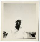 Photograph of an Arab, with village to the rear, possibly in Egypt, c. 1942