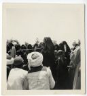 Photograph of Arab women and children, standing, with seated Arab men, possibly in Egypt, c.1942