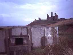 Cushat Knock pillbox and foxhole, Dunstanburgh.
Photograph by Northumberland County Council, 1999.