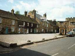 Buildings on the west side of The Square, Blanchland. Photo Northumberland County Council.