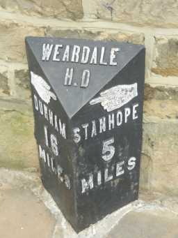 Close up photograph of Milestone in front of 12 High Street, Wolsingham 2016