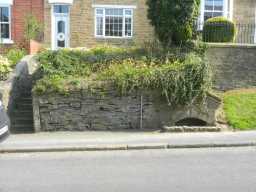 Fountain in wall in front of number 9 North View from across road 2016