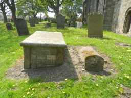 Brass tomb outside church of St John Evangelist - view end-on