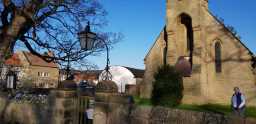 St. Mary's Church, Piercebridge and nearby Nissan hut in the early evening March sunlight 19-MAR-2022